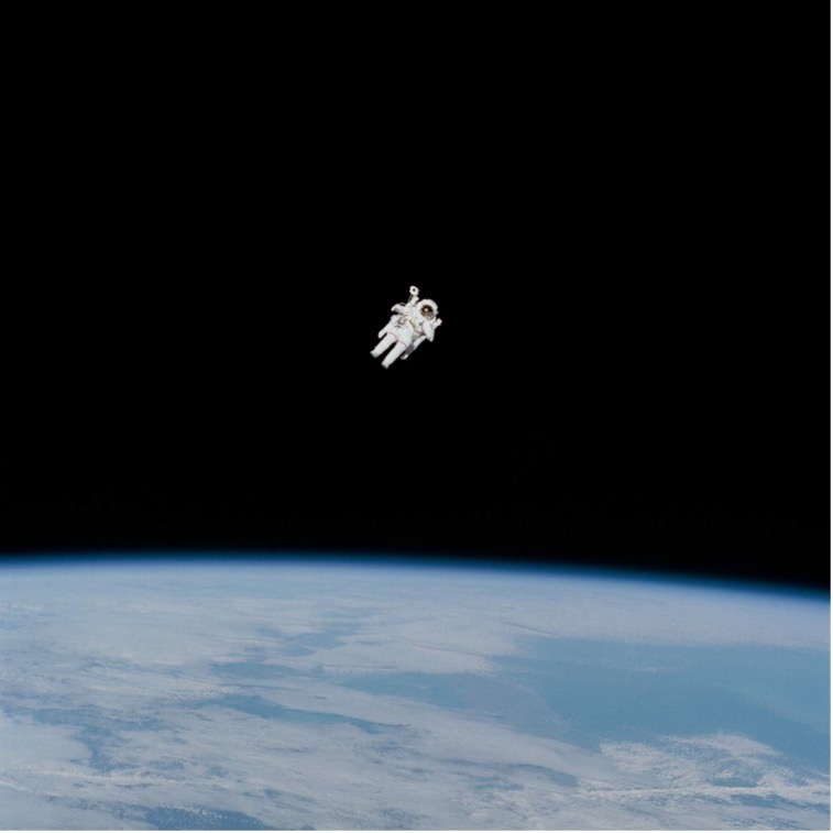 An astronaut floating in space with the Earth in the background.